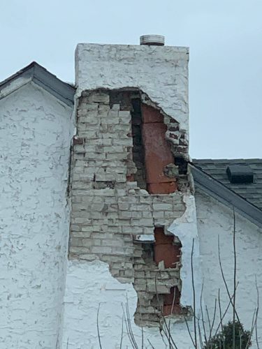 Damage at stucco-covered chimney