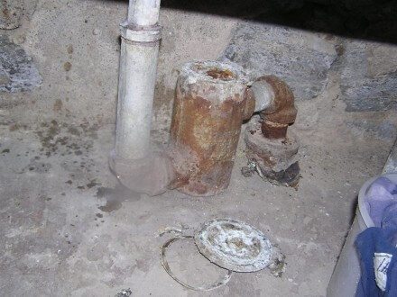 Corroded cap at drum trap