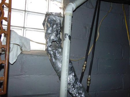 Damaged semi-rigid aluminum clothes dryer transition duct