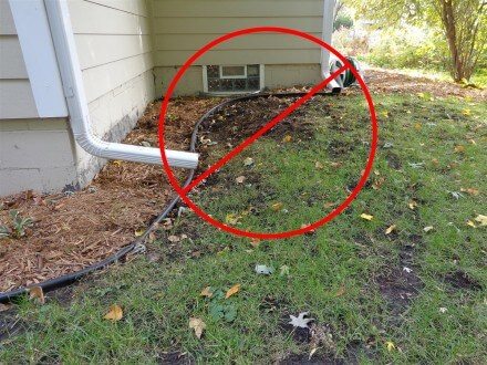 Downspouts discharging next to house