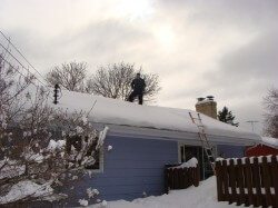 Home Inspector on Snow Covered Roof