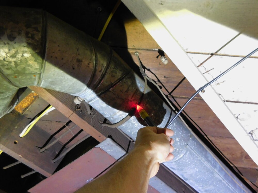Yikes. That’s live knob & tube wiring being used to support the ductwork. Again, yikes.