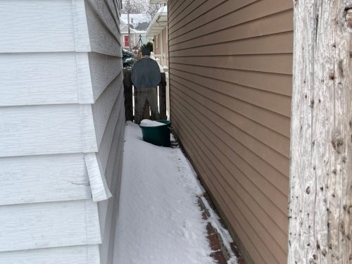 Man with hands in pockets at fence