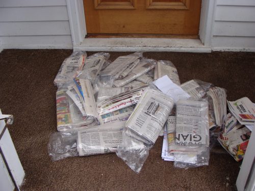 Newspapers piled up